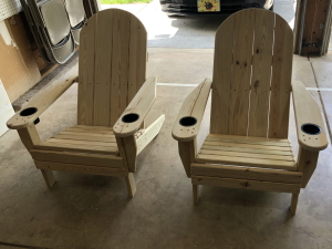 Two chairs with rounded backs and dual cupholders