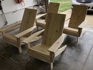 Four chairs with squared backs and no cupholders, from the front
