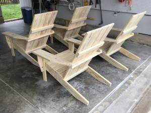 Four chairs with squared backs and no cupholders, from the back