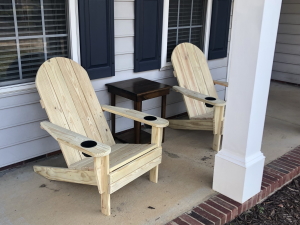 Two chairs with rounded backs and dual cupholders, with slightly narrowed armrests